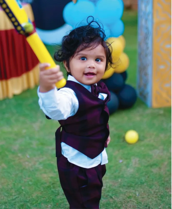Birthday cake with candles surrounded by guests